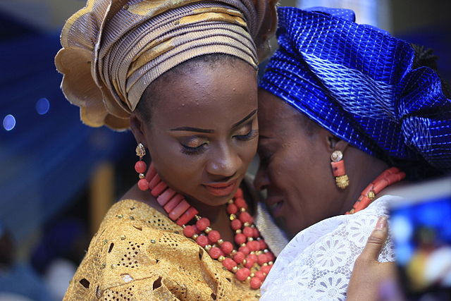 A Yoruba bride and her mother, wearing traditional dress